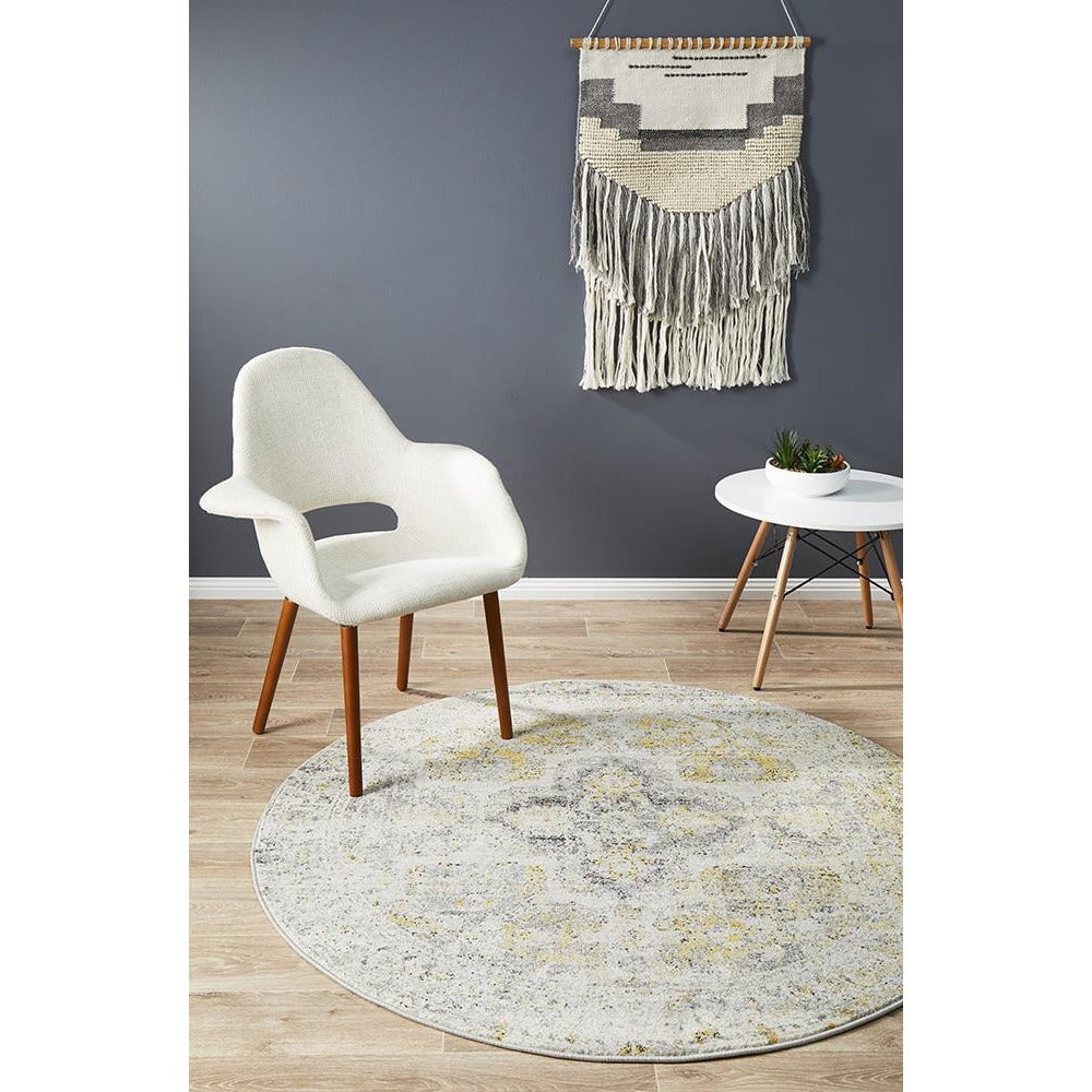 Round transitional bohemian rug in silver grey with subtle multi-colored floral patterns on light background.