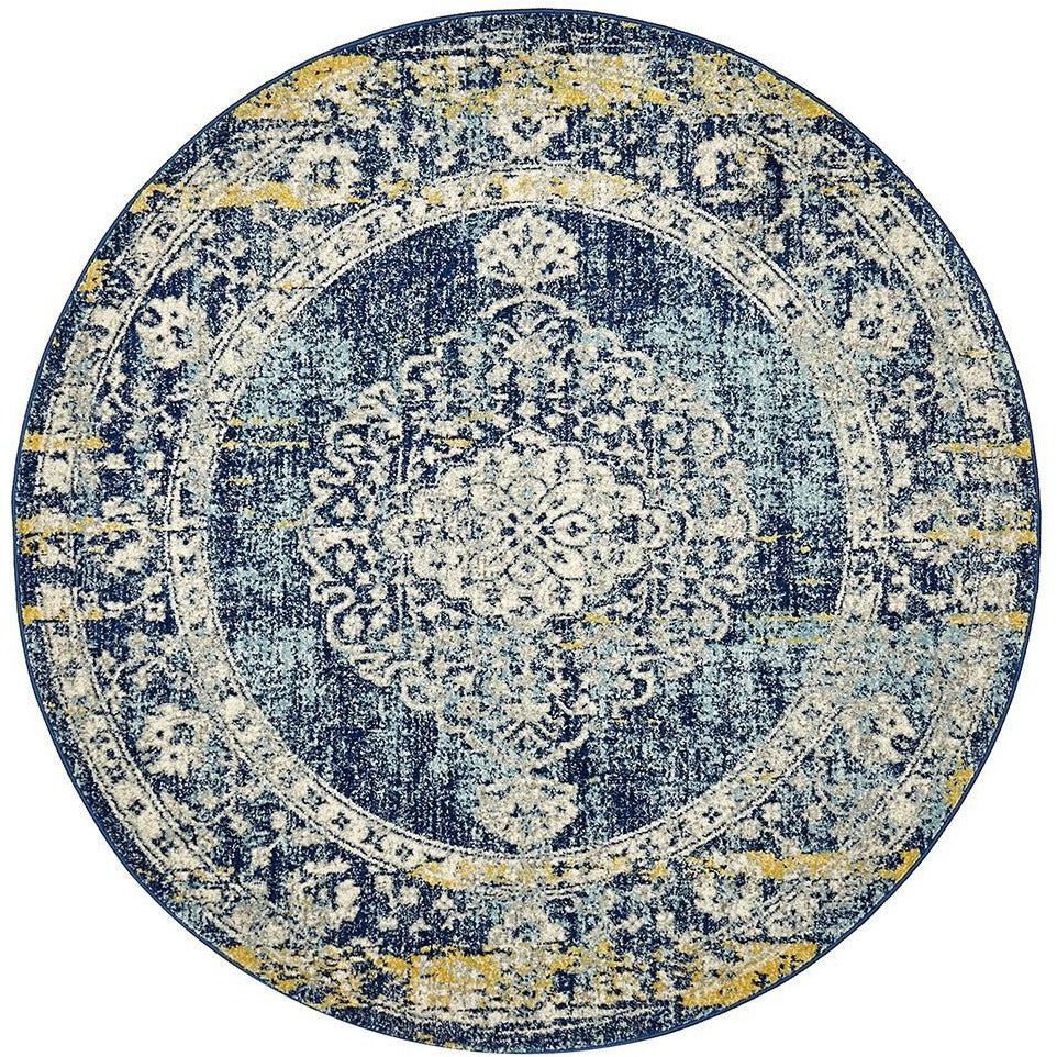 Round navy blue bohemian rug with intricate cream and yellow floral patterns on polypropylene material.