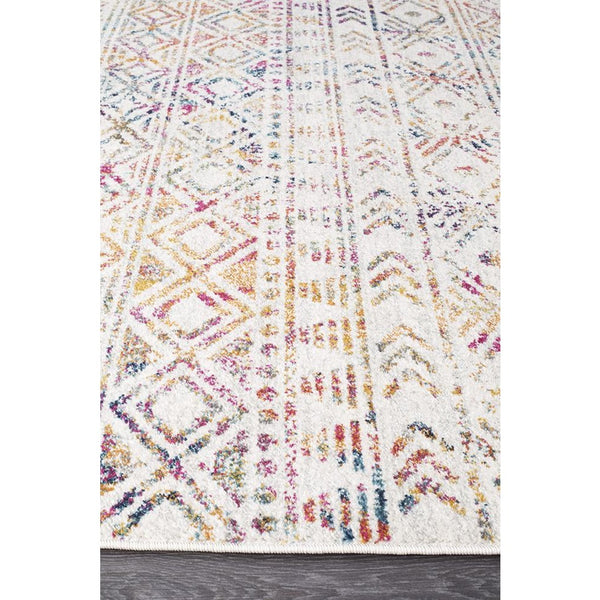 Multi-coloured modern tribal boho rug with geometric patterns on white background.
