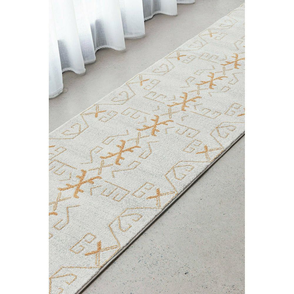 Beige and gold runner rug with geometric modern patterns and subtle texture detail.