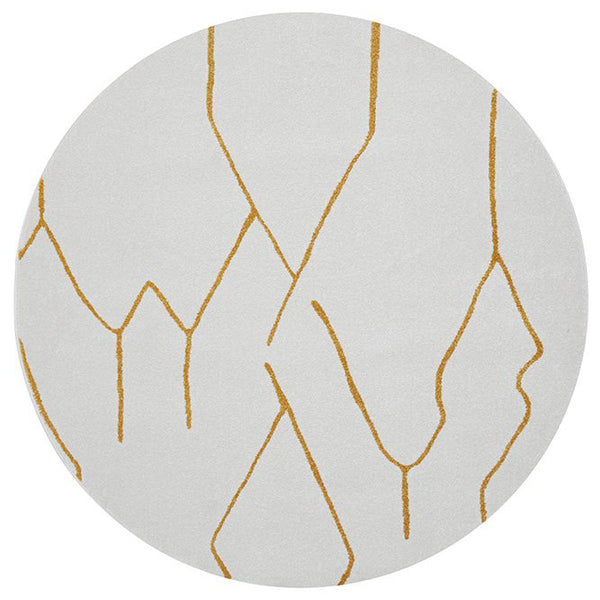Round modern rug with white background and abstract gold geometric lines pattern.