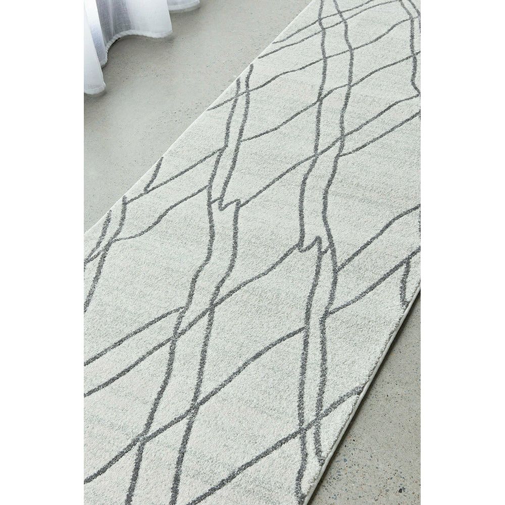 Cream grey runner rug with abstract geometric dark grey lines on soft polypropylene fiber.