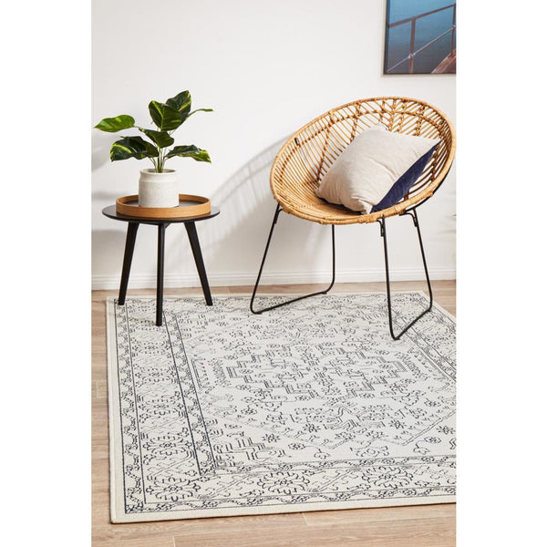 White and grey Coogee 4454 tribal rug with traditional geometric patterns on hardwood floor.