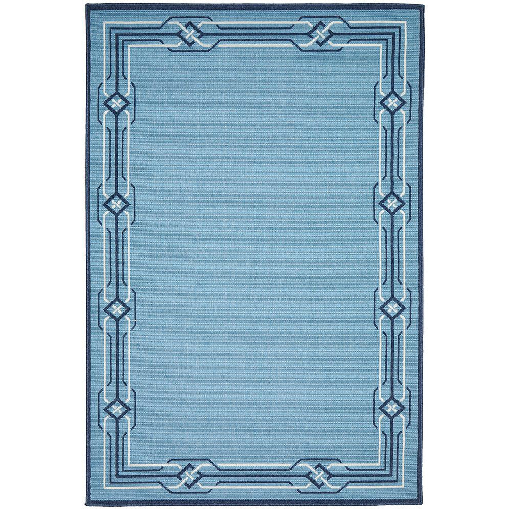 Rectangular blue coastal rug with geometric border pattern and woven texture.