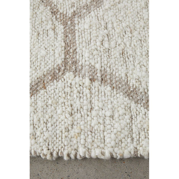 Neutral-toned wool flatwoven rug with subtle geometric pattern and chunky texture.