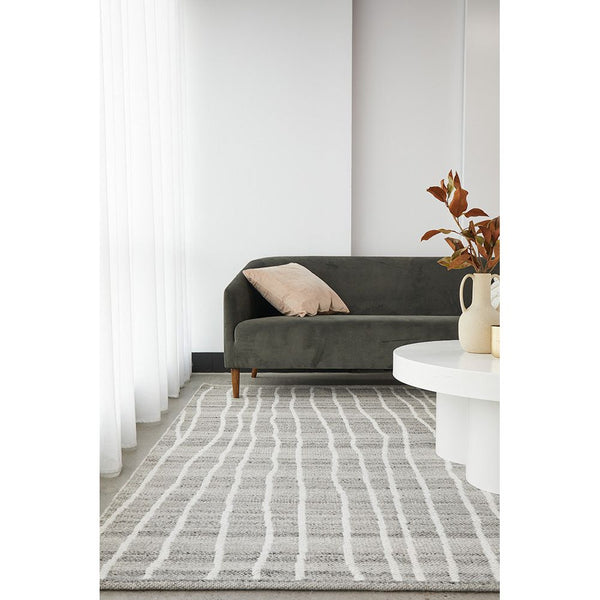 Neutral-toned wool blend rug with subtle white linear pattern in modern living room setting.