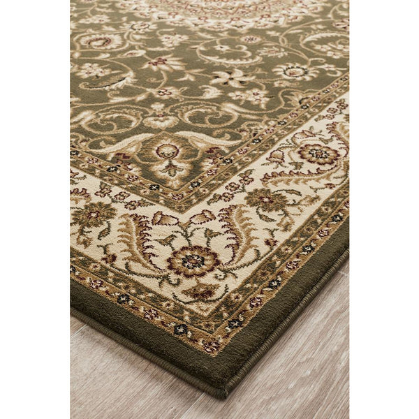 Green traditional patterned rug with ivory floral border and detailed medallion design.