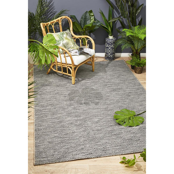 Grey Siderno 4110 modern indoor outdoor rug with subtle textured pattern on wooden floor.